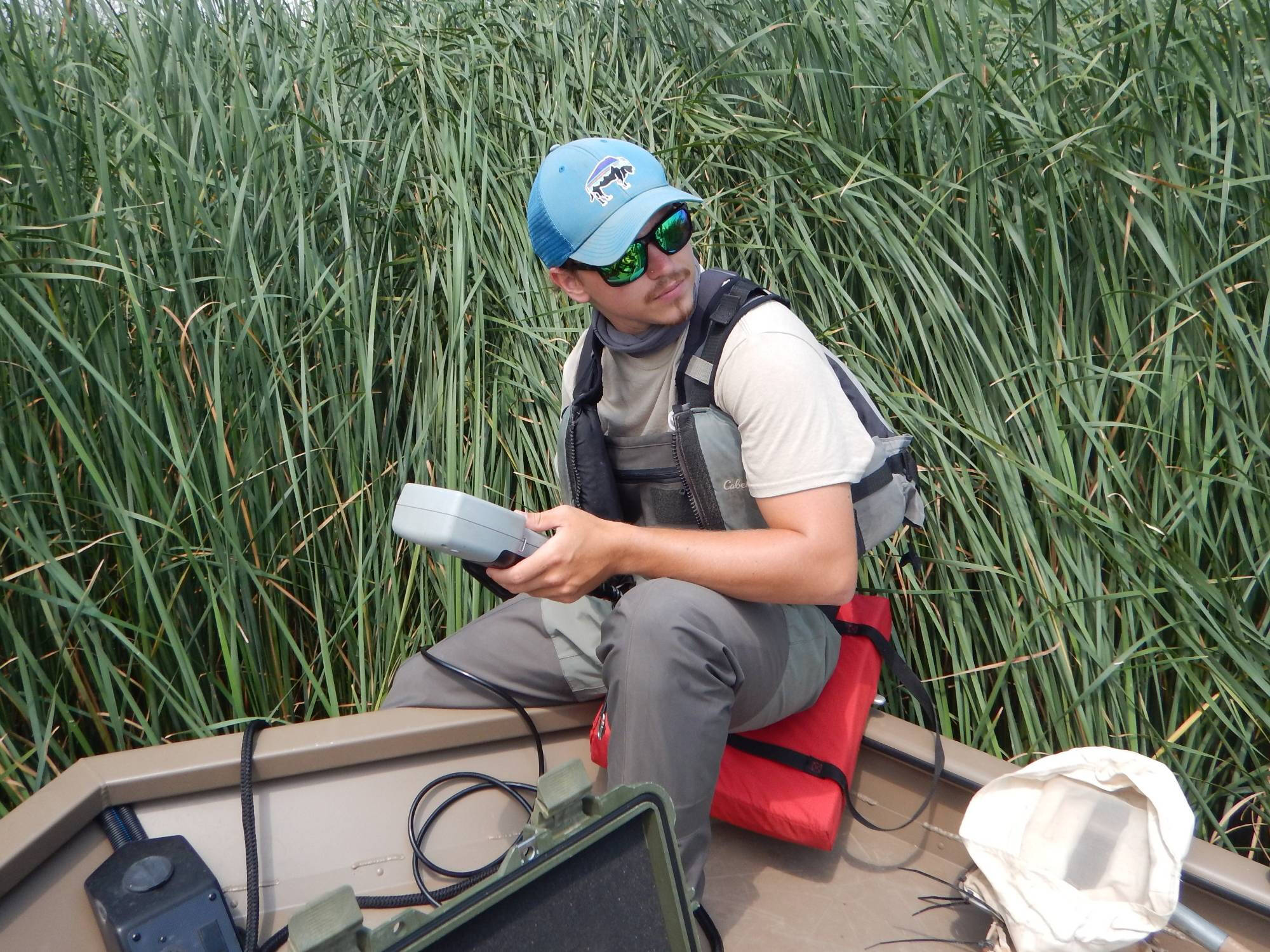 Zak Collins records data on a water quality sonde.